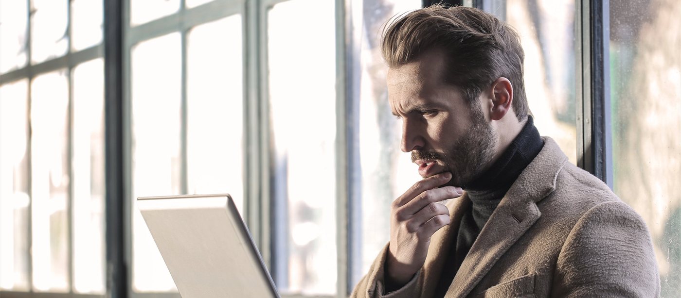 A man thinking at his laptop